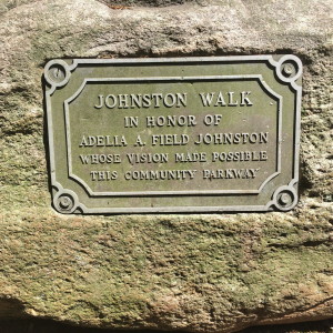 This plaque appears on a boulder at the beginning of Johnston Walk, which is the name given to the path through the Community Parkway that Johnston worked to create. 